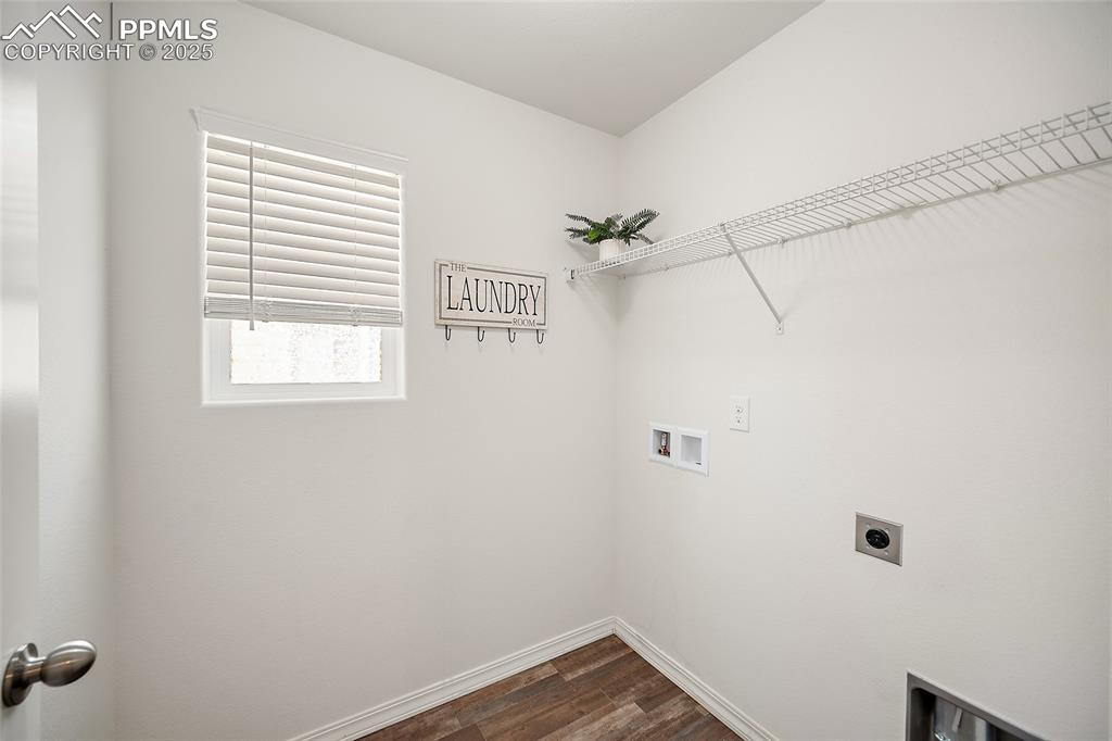 Image 22 of 50: Laundry area featuring electric dryer hookup, washer hookup, and dark wood-