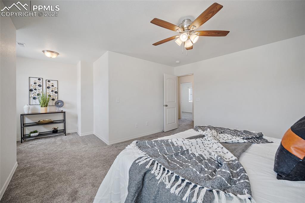 Image 31 of 50: Bedroom with carpet and ceiling fan