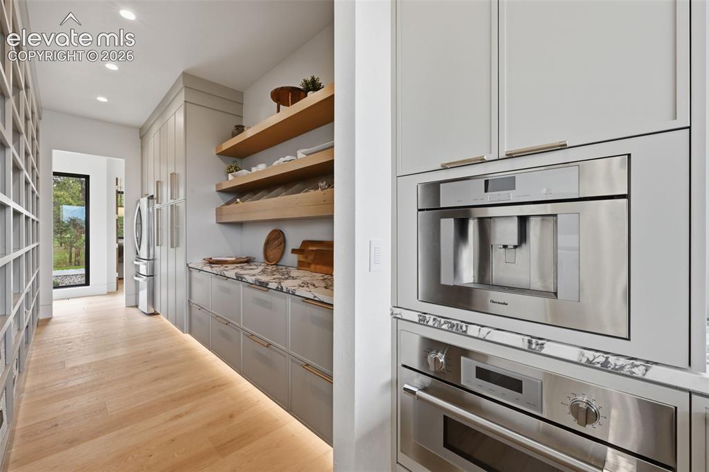 Image 16 of 50: Pantry, built in microwave and espresso maker