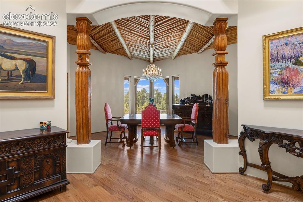Image 13 of 46: Stunning hand-carved wood columns and a sweeping archway create a dramatic