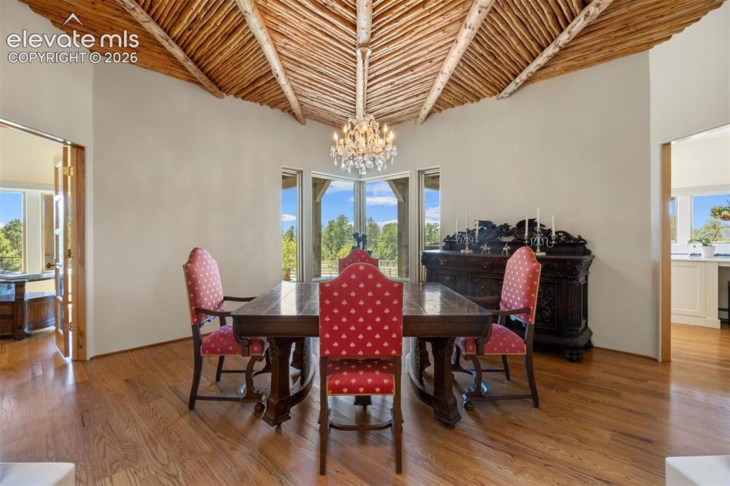 Image 14 of 46: Stunning hand-carved wood columns and a sweeping archway create a dramatic