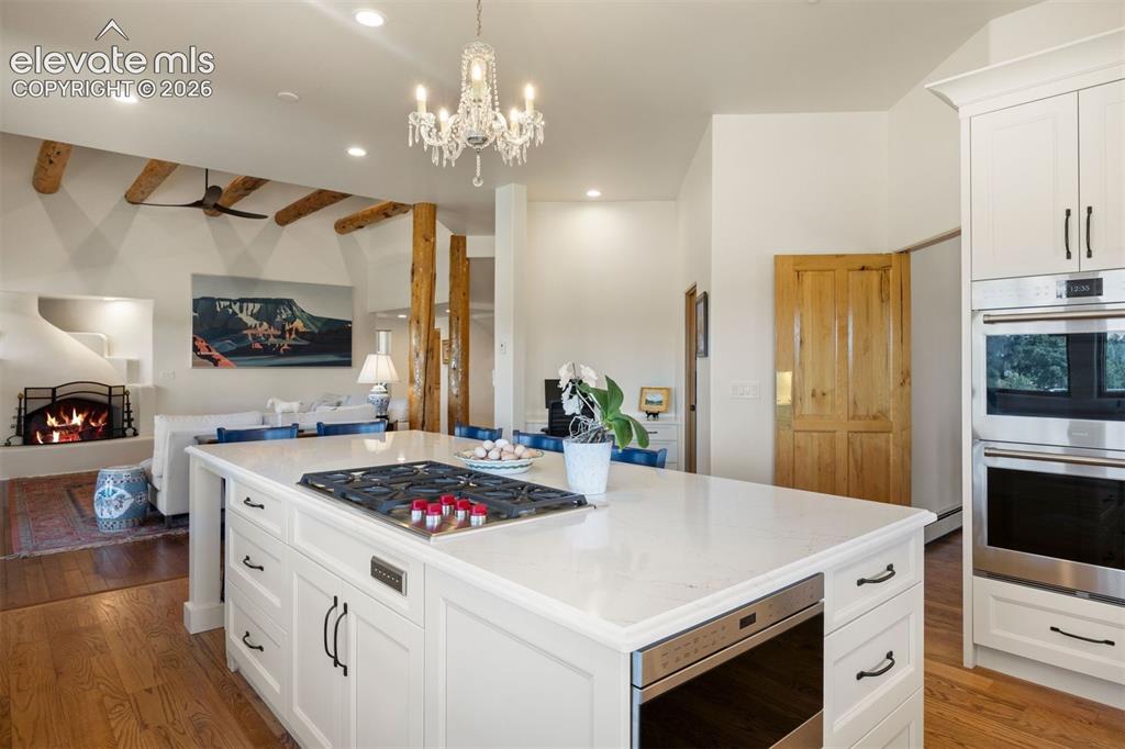 Image 16 of 46: The kitchen is spacious with large center island with seating, walk-in pant