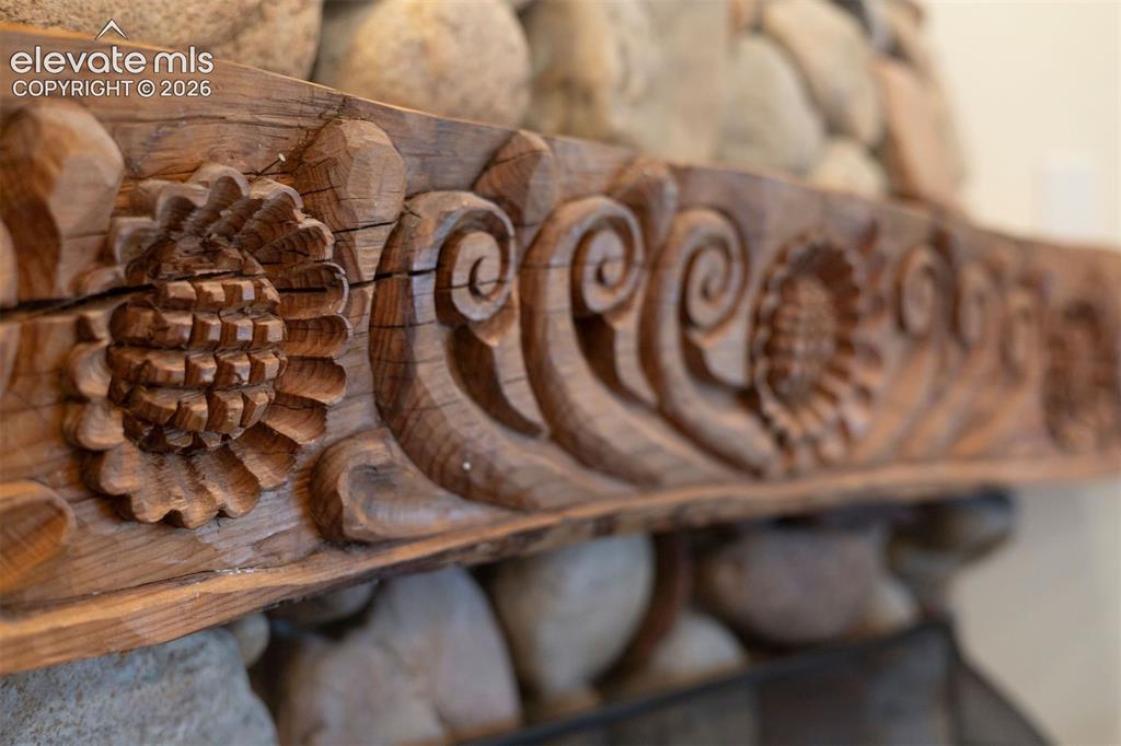 Image 19 of 46: Detailed mantle featuring intricate pinecone and scroll detailing, an unden