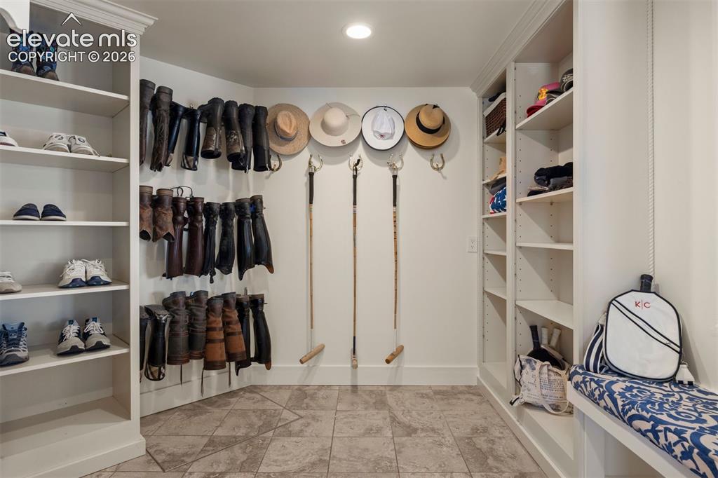 Image 25 of 46: Spacious two-part mudroom room, thoughtfully outfitted as a true equestrian