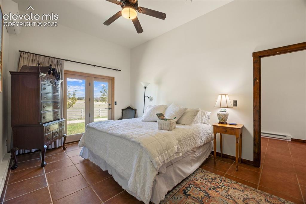 Image 32 of 46: Spacious bedroom in the casita, with two closets, mini-split AC, and glass