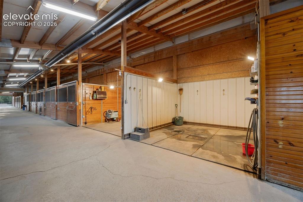 Image 38 of 46: Two wash stalls and three grooming stalls, plus a dedicated grain room, too