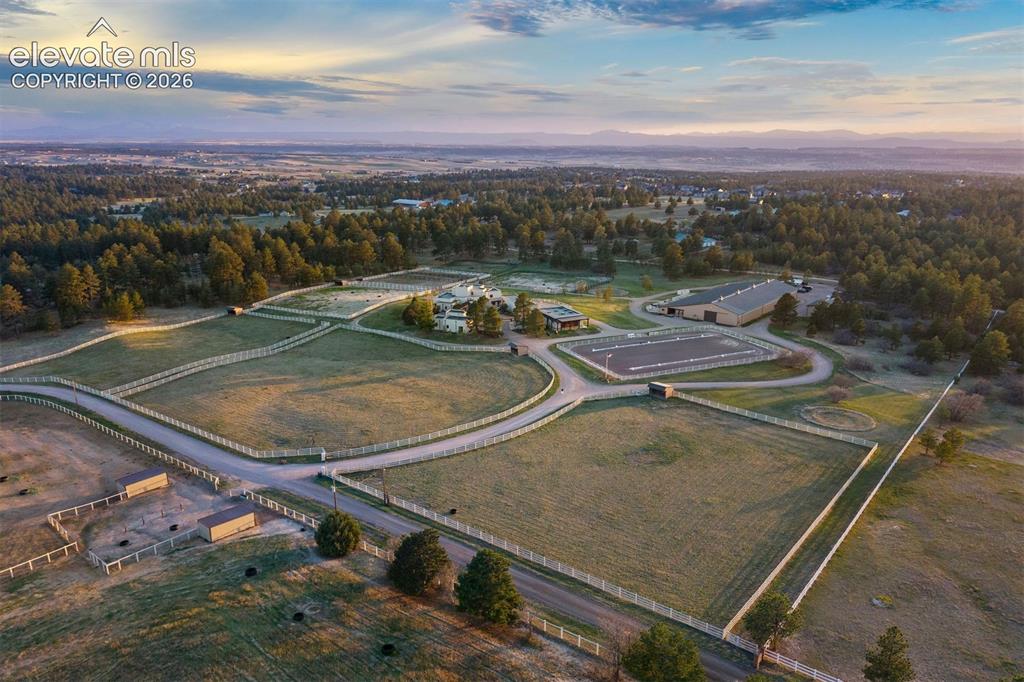 Image 45 of 46: Overview of the 40 acres - A gravel driveway wraps the property, connecting