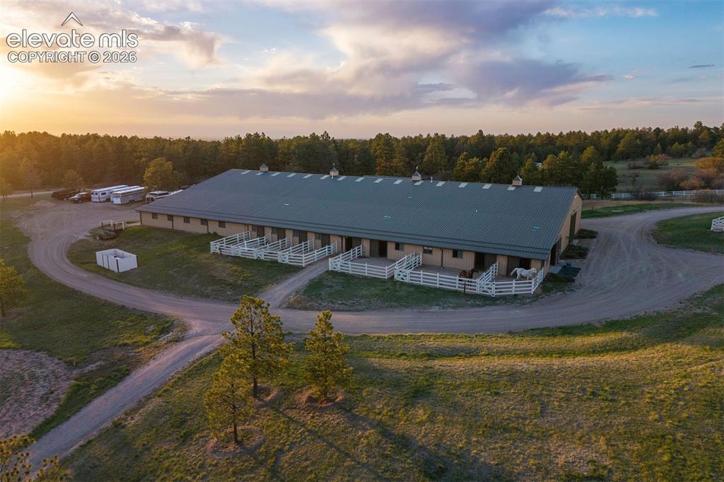 Image 6 of 46: The equestrian facility features a 20-stall barn with heated stalls, three