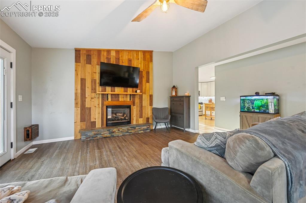Image 8 of 35: Living room with custom fire place, tv stays