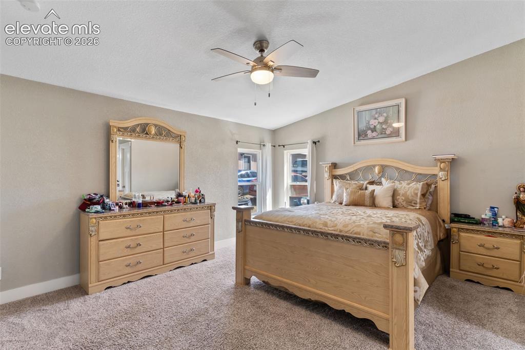 Image 21 of 34: Spacious room featuring carpet flooring, neutral-toned walls, a ceiling fan