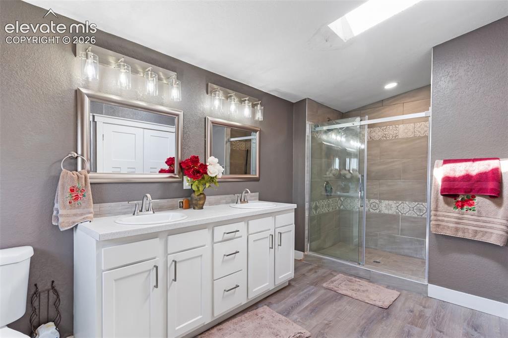 Image 23 of 34: Spacious bathroom featuring a double vanity with white cabinetry and chrome