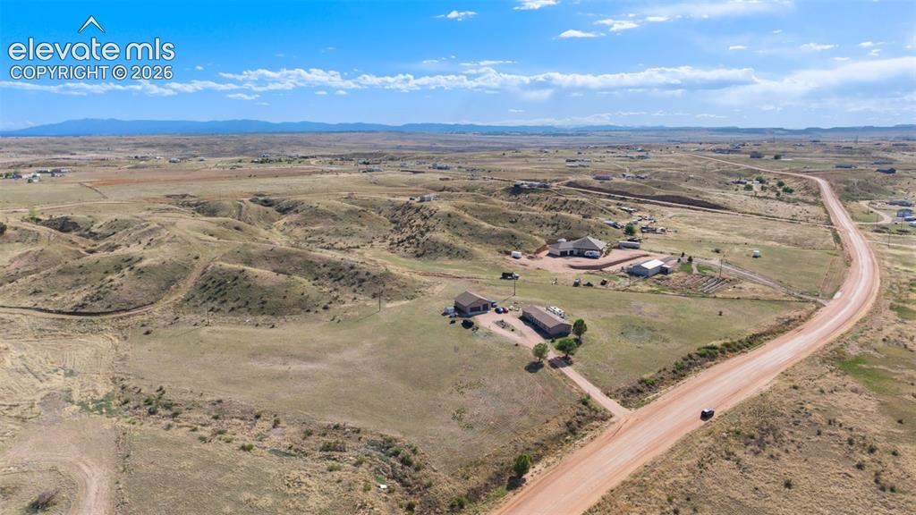 Image 32 of 34: Expansive rural landscape featuring a main residence, an additional structu