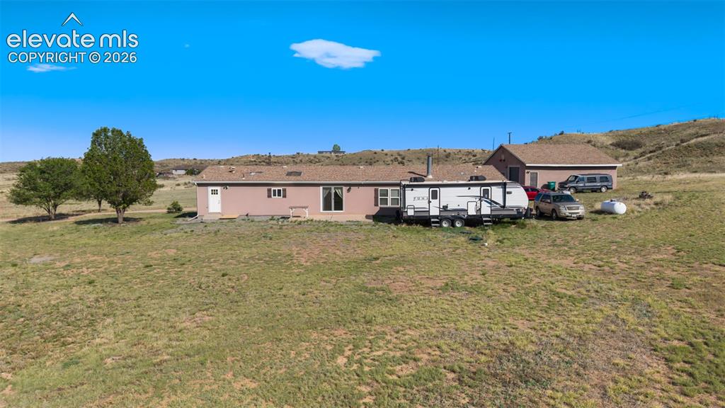 Image 34 of 34: Single-story property with a light-colored exterior and a brown shingle roo