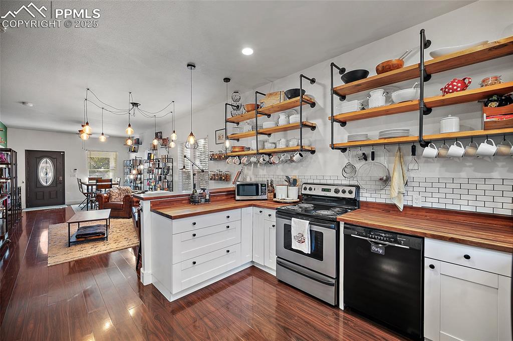Image 11 of 36: Bedroom or Office space featuring dark wood-style floors and baseboards
