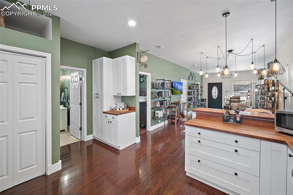 Image 14 of 36: Kitchen featuring butcher block countertops, appliances with stainless stee