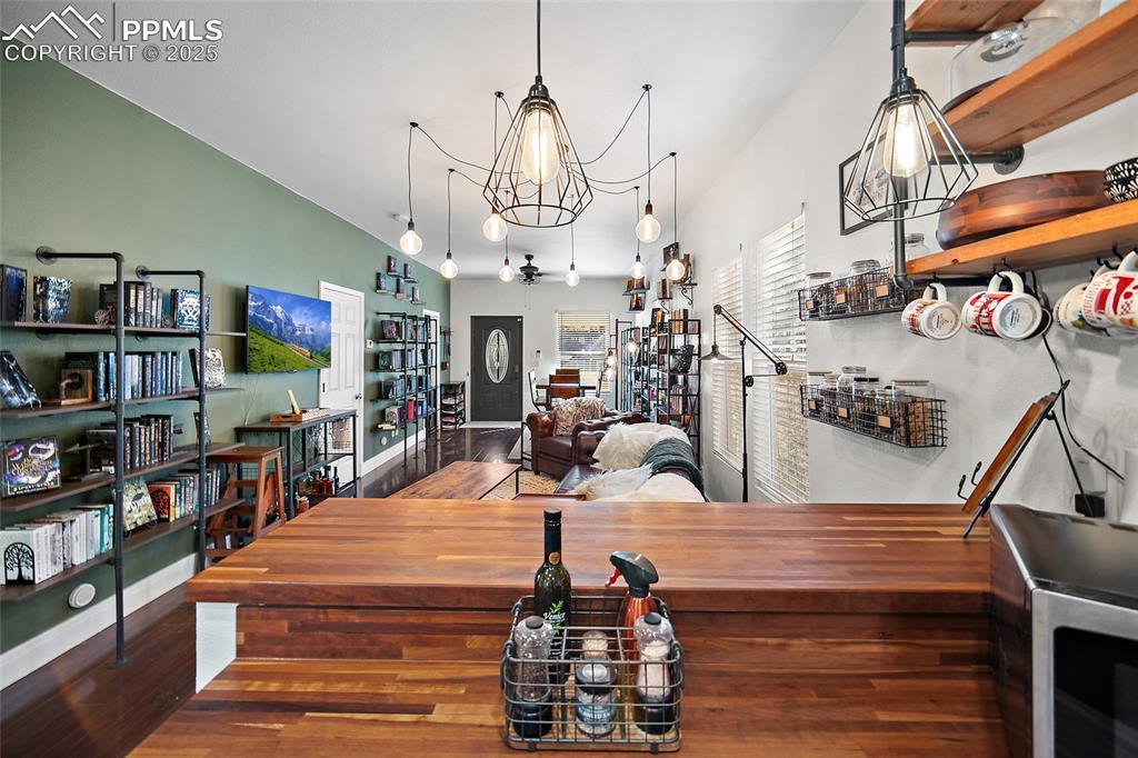 Image 15 of 36: Kitchen featuring stainless steel appliances, white cabinetry, butcher bloc