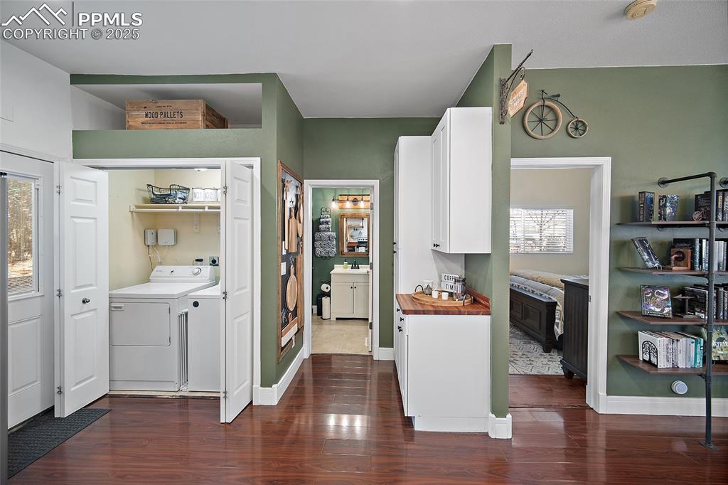 Image 17 of 36: Living room with dark wood-style flooring and recessed lighting