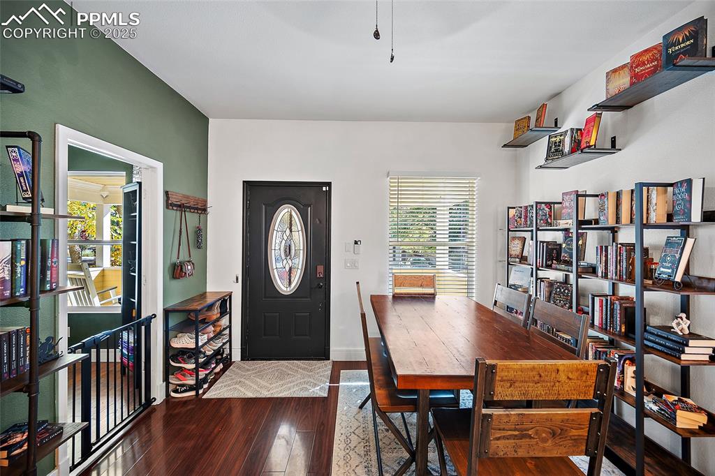 Image 21 of 36: Dining space featuring dark wood-style flooring and baseboards