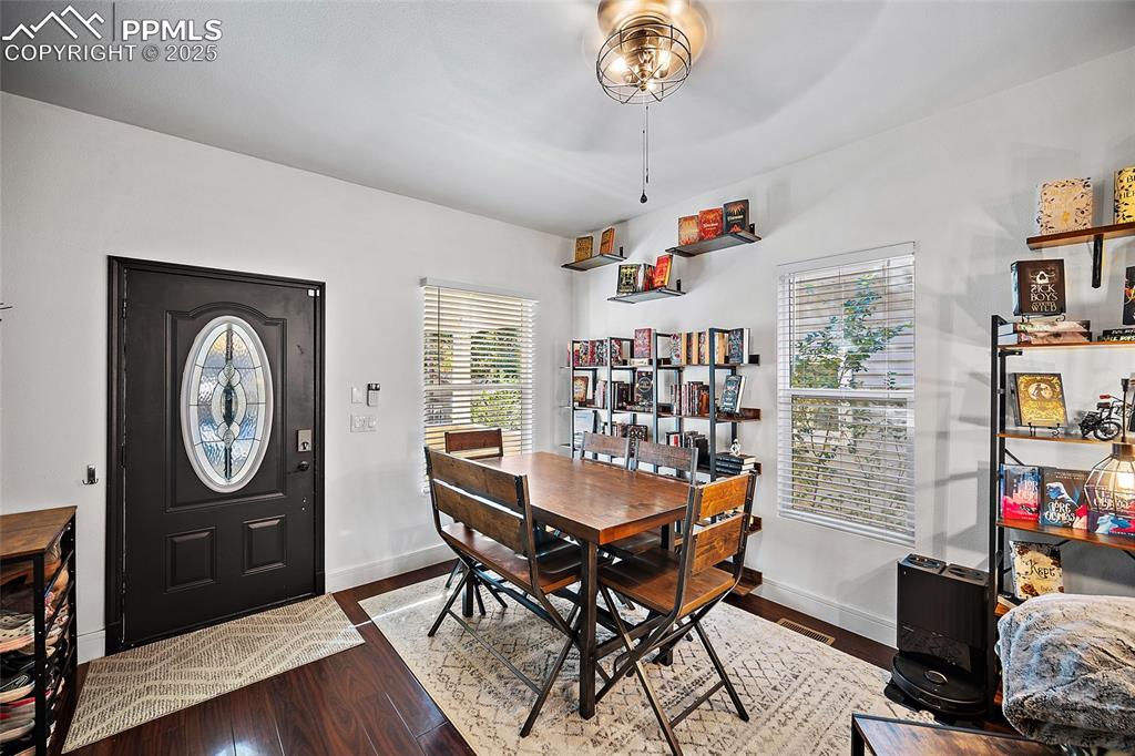 Image 22 of 36: Kitchen with white cabinetry, dark wood-style floors, and wood counters