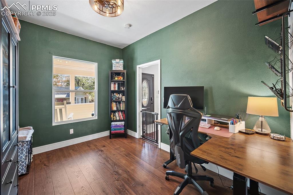 Image 24 of 36: Laundry area with independent washer and dryer and wood finished floors