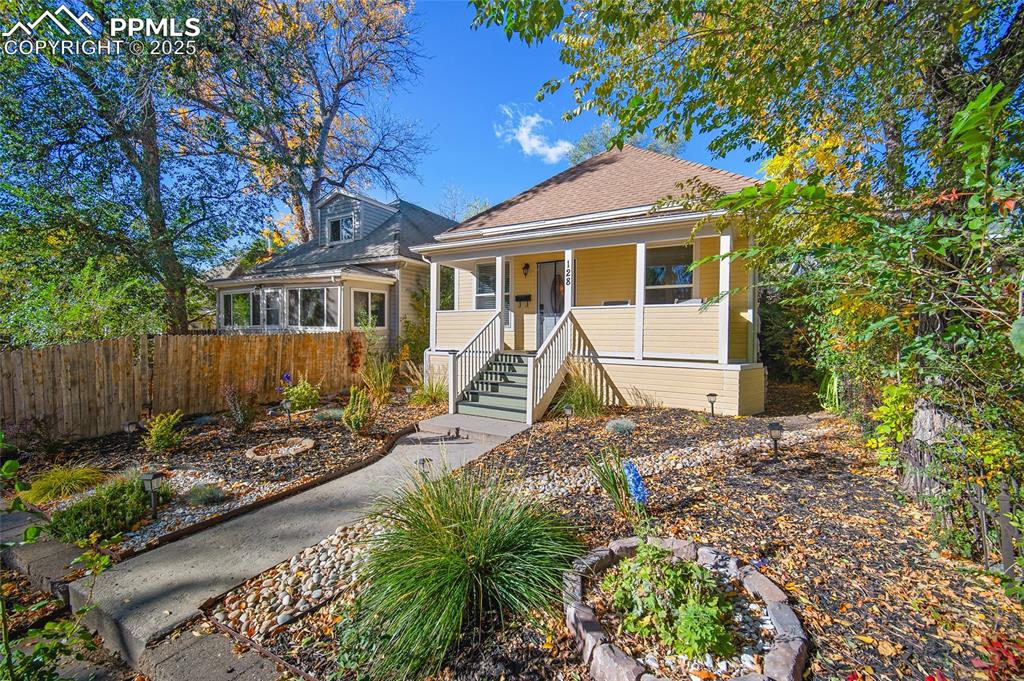 Image 28 of 36: Bedroom with dark wood finished floors and baseboards