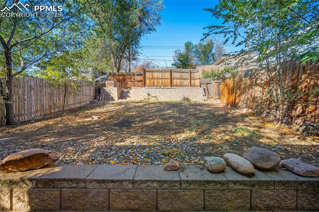 Image 29 of 36: Spacious fenced backyard offering endless possibilities for your dream gard