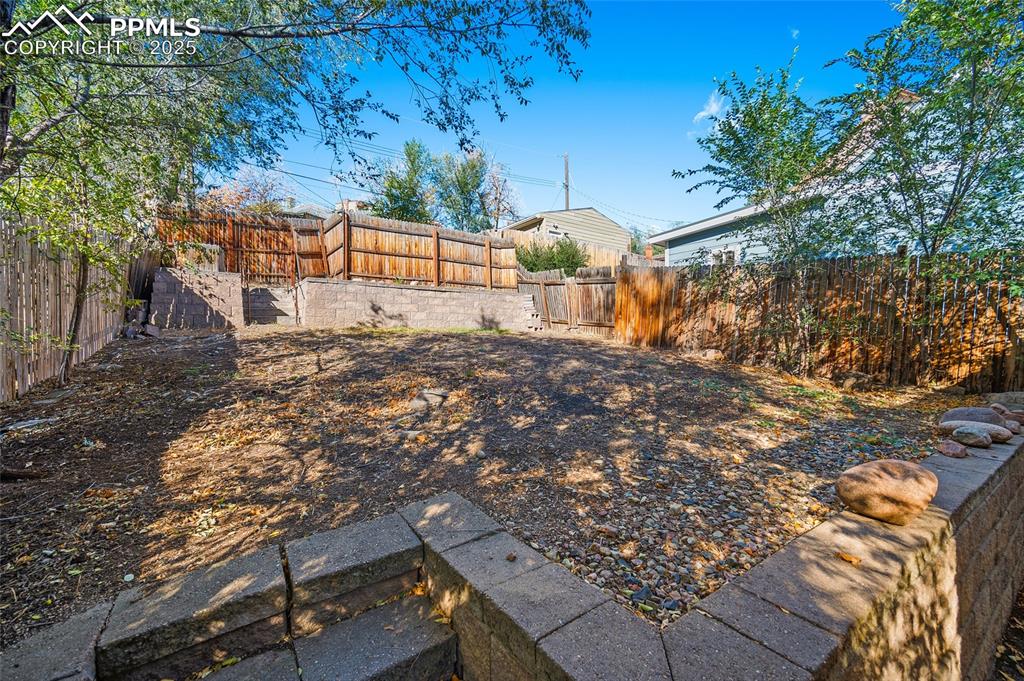 Image 30 of 36: View of fenced backyard