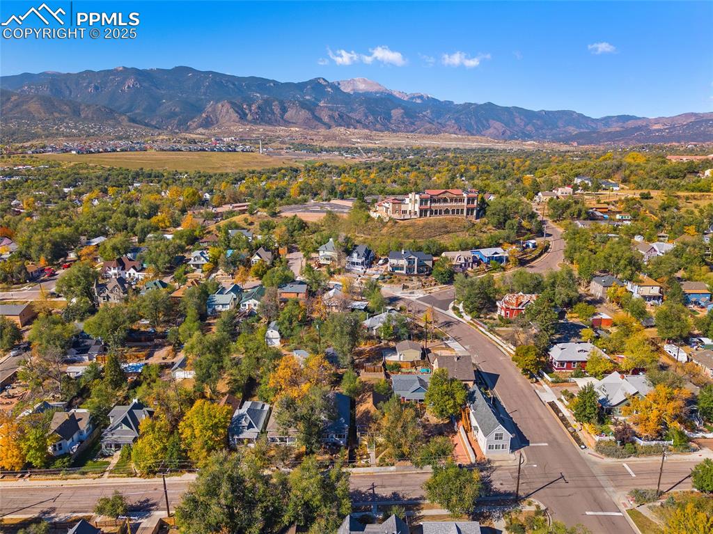 Image 33 of 36: View of property location with mountains and nearby suburban area