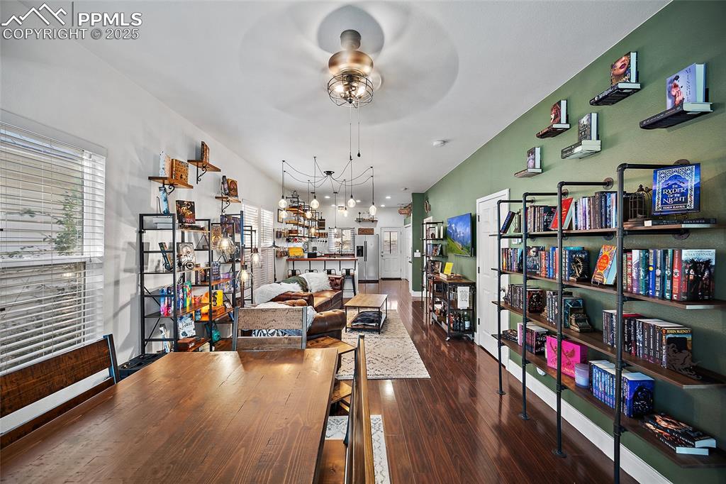 Image 6 of 36: Living room with dark wood-style floors, plenty of natural light, and a cei