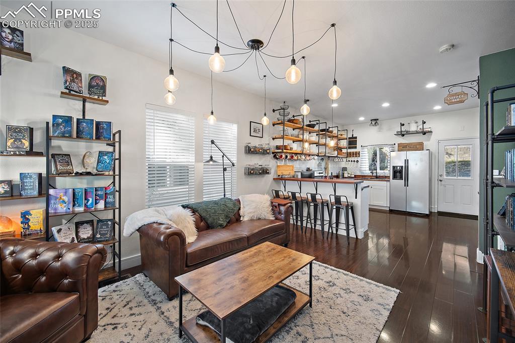 Image 7 of 36: Dining room featuring dark wood-style flooring