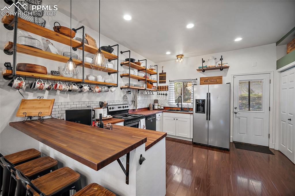 Image 8 of 36: Dining area with dark wood-style flooring