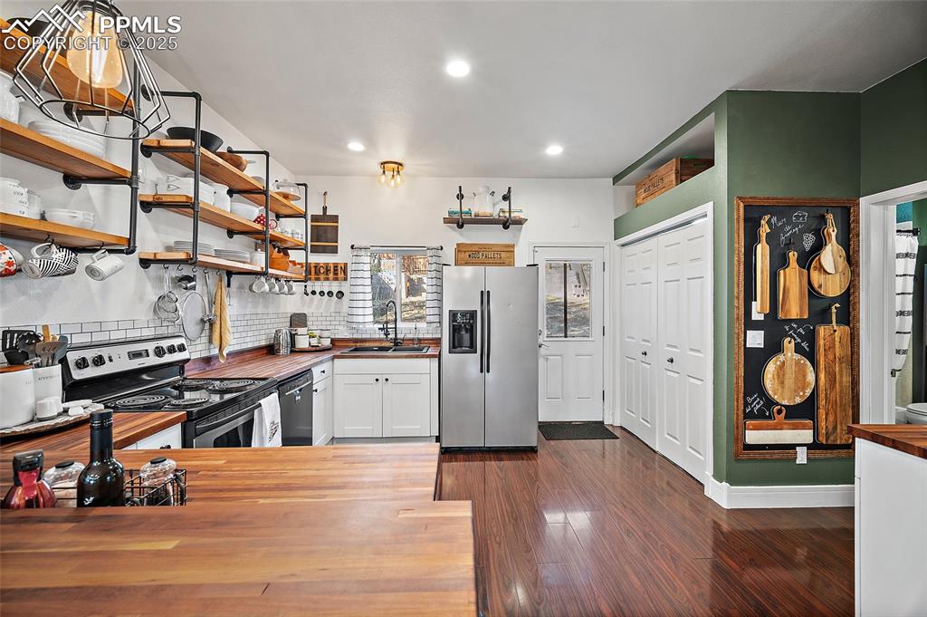 Image 9 of 36: Dining area featuring dark wood finished floors and ceiling fan
