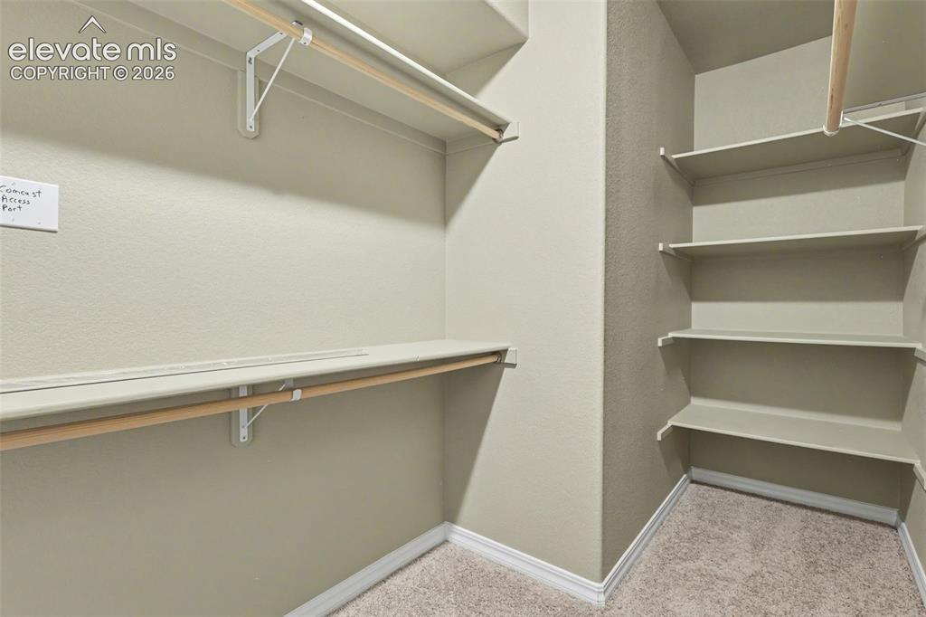 Image 16 of 34: Primary suite walk-in closet
