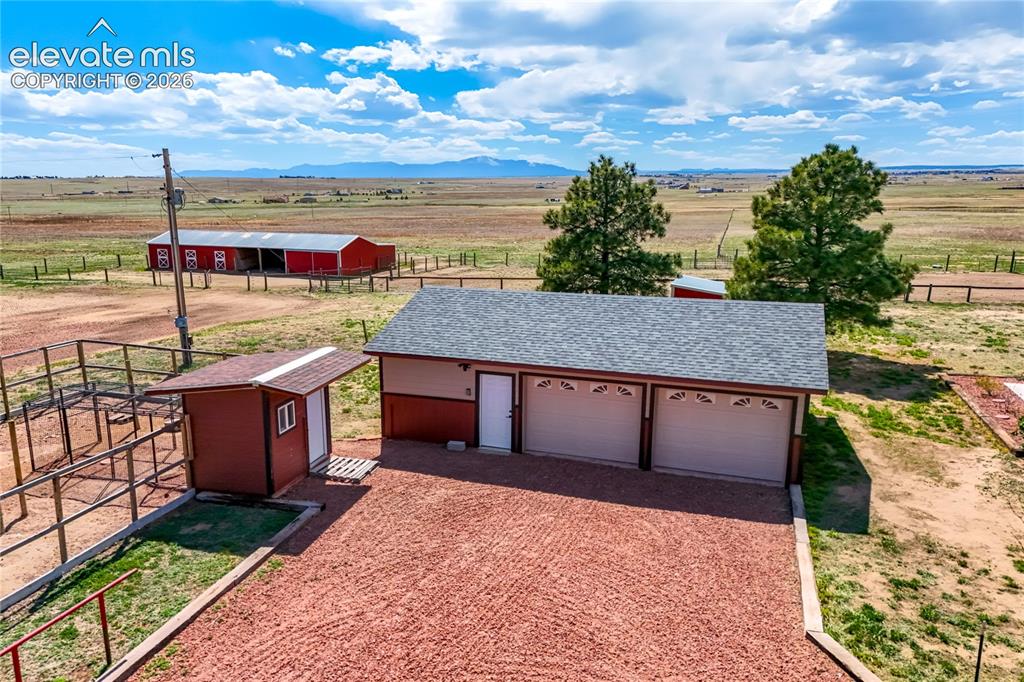 Image 11 of 50: 2 car garage with shop area, chicken coop to left
