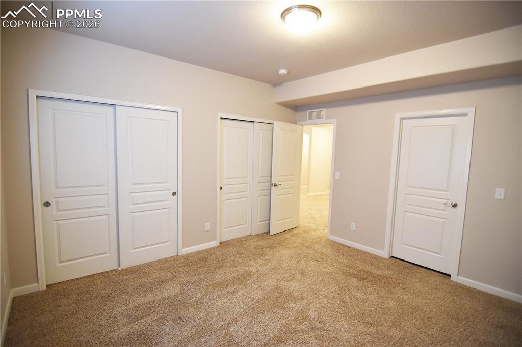 Image 24 of 29: Basement bedroom 1with twin closets and Hollywood bath adjoining!