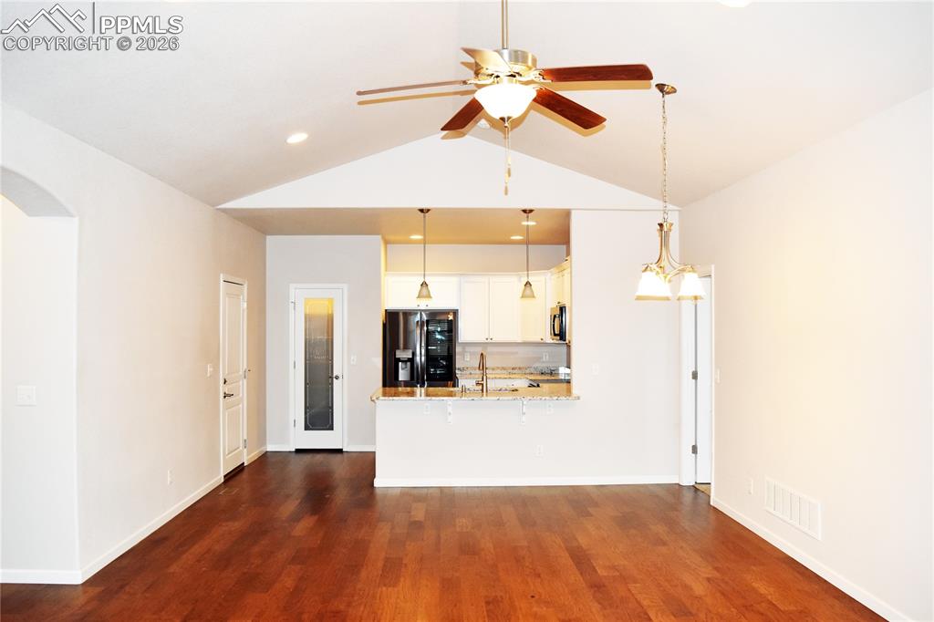 Image 8 of 29: Living/dining area with kitchen beyond