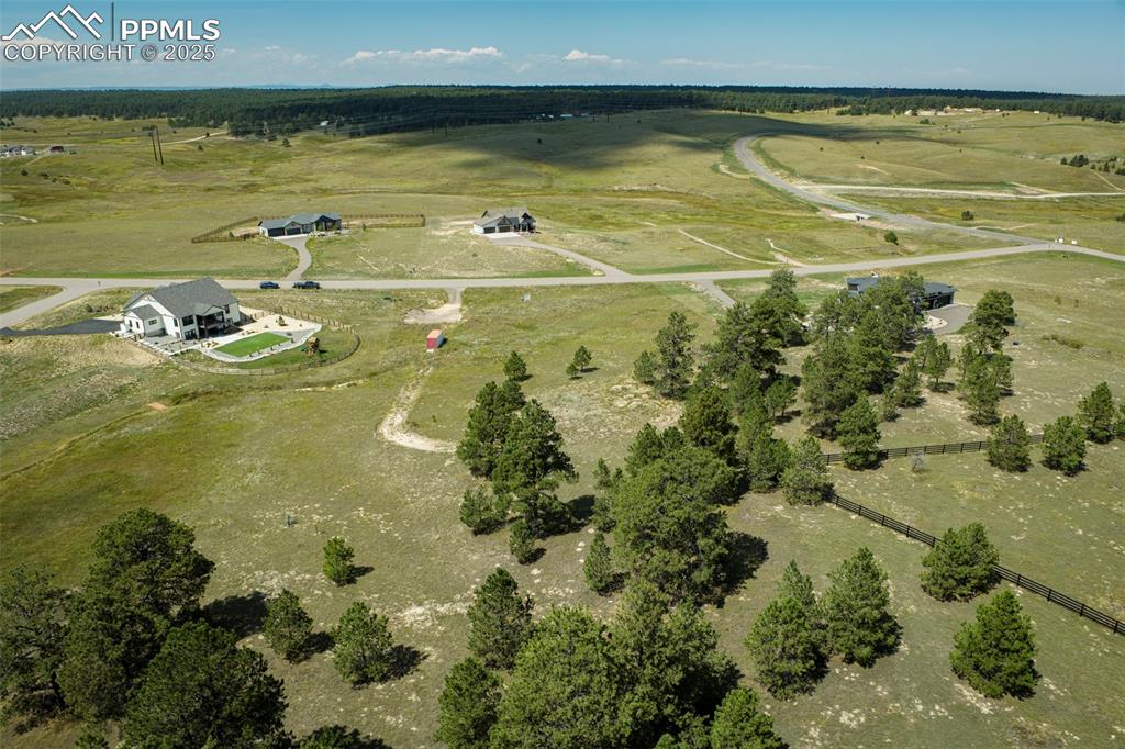 Image 8 of 16: Aerial view of property and surrounding area with rural landscape