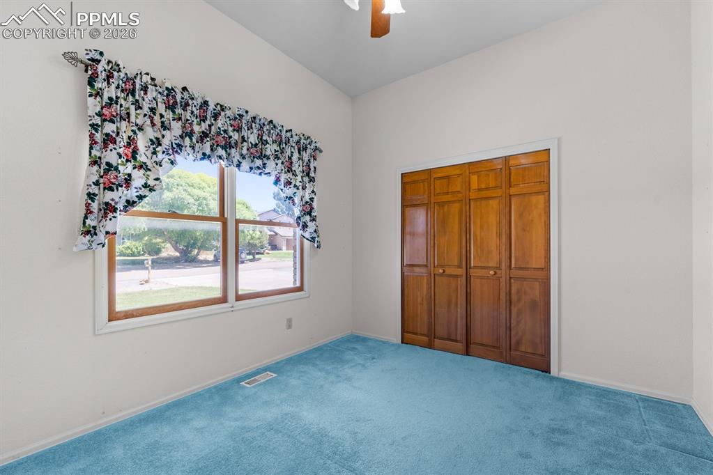 Image 16 of 38: Unfurnished bedroom featuring carpet, ceiling fan, and a closet