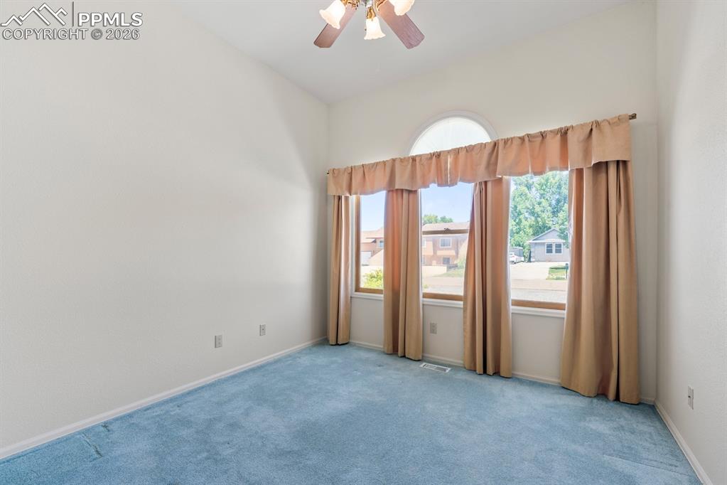 Image 20 of 38: Carpeted spare room featuring a ceiling fan and baseboards