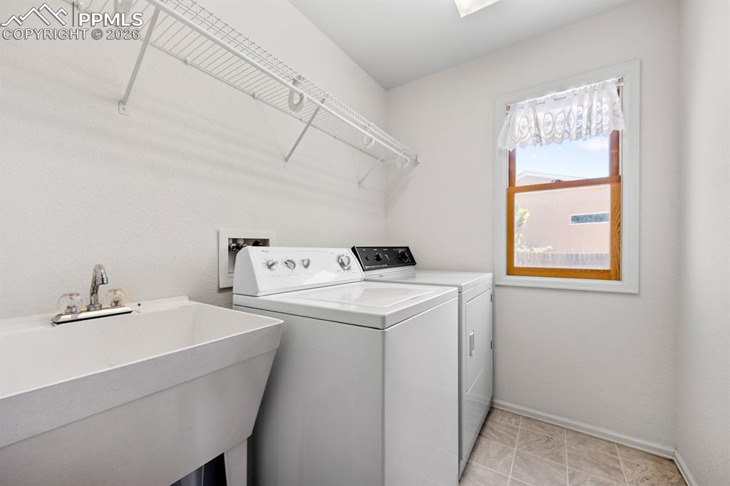 Image 22 of 38: Laundry area featuring baseboards and washer and dryer