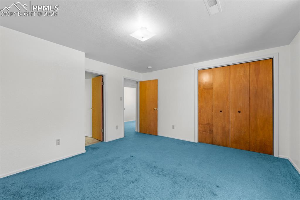 Image 27 of 38: Unfurnished bedroom featuring a closet and carpet flooring