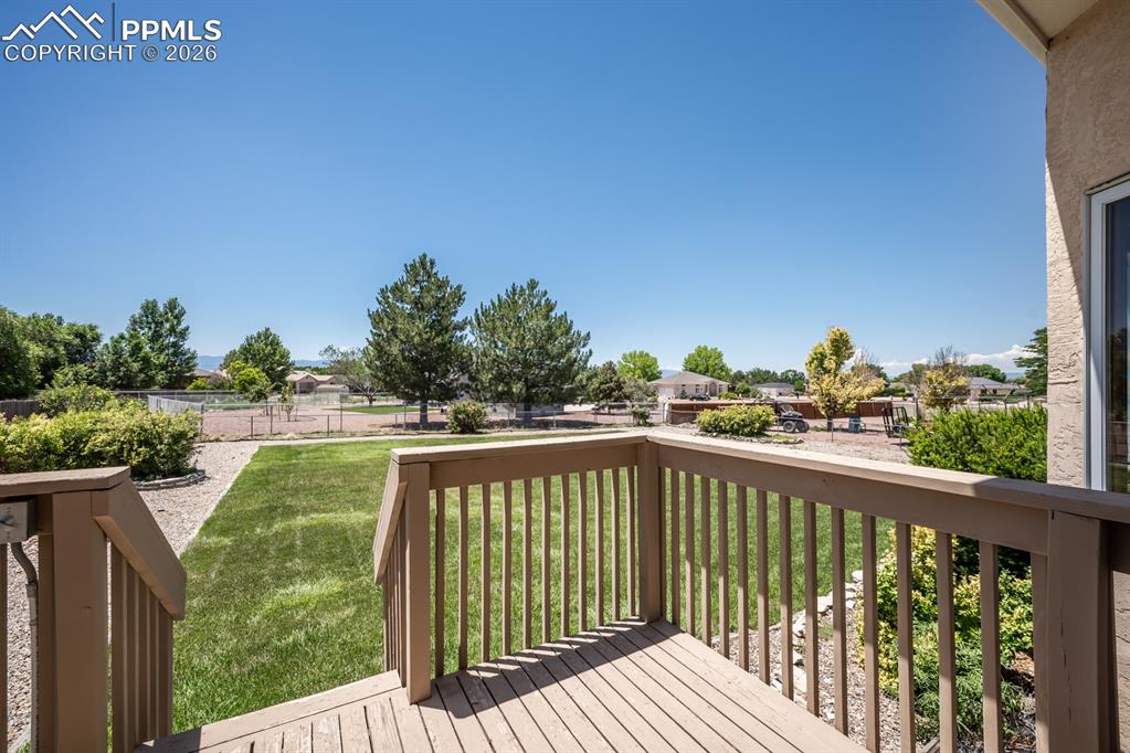 Image 35 of 38: Wooden terrace with a residential view and a yard