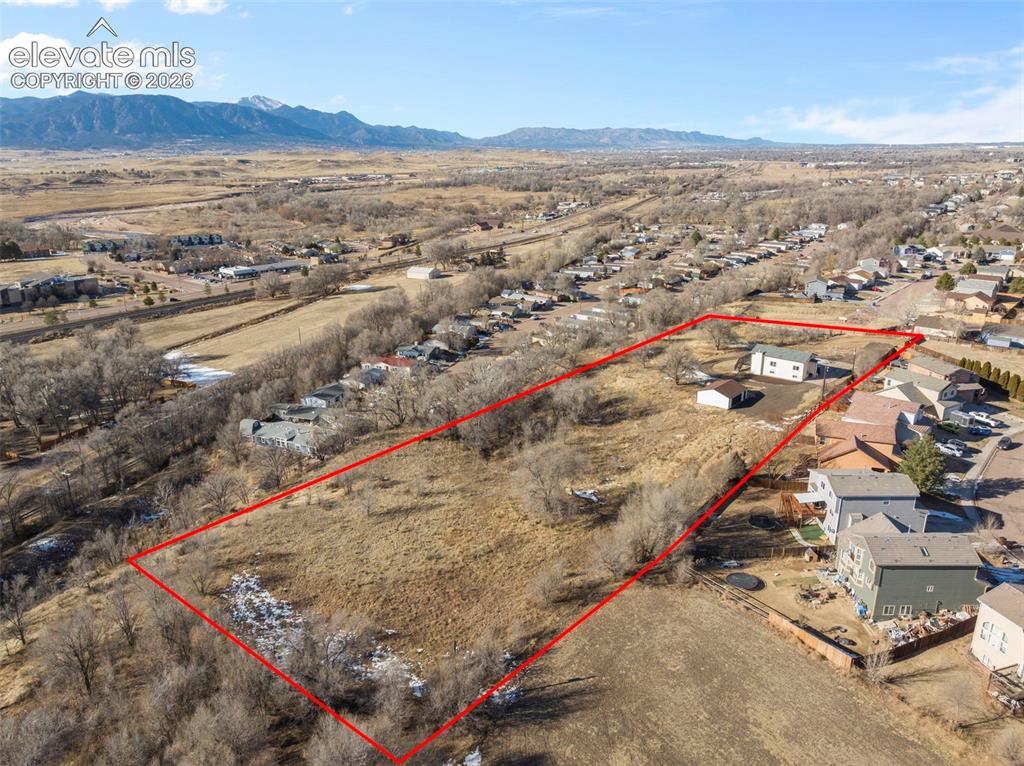 Image 10 of 49: Expansive parcel featuring a defined boundary, existing structure, outbuild