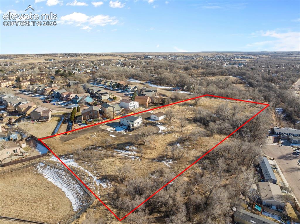 Image 11 of 49: Expansive lot featuring a single structure and undeveloped land