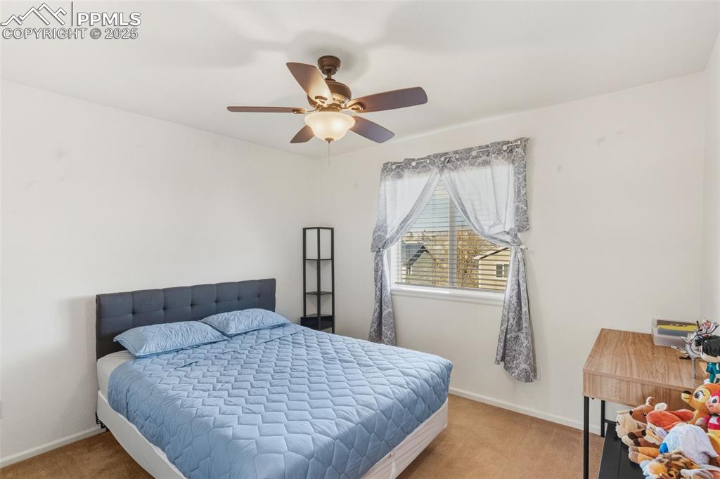 Image 19 of 33: Carpeted bedroom featuring baseboards and a ceiling fan