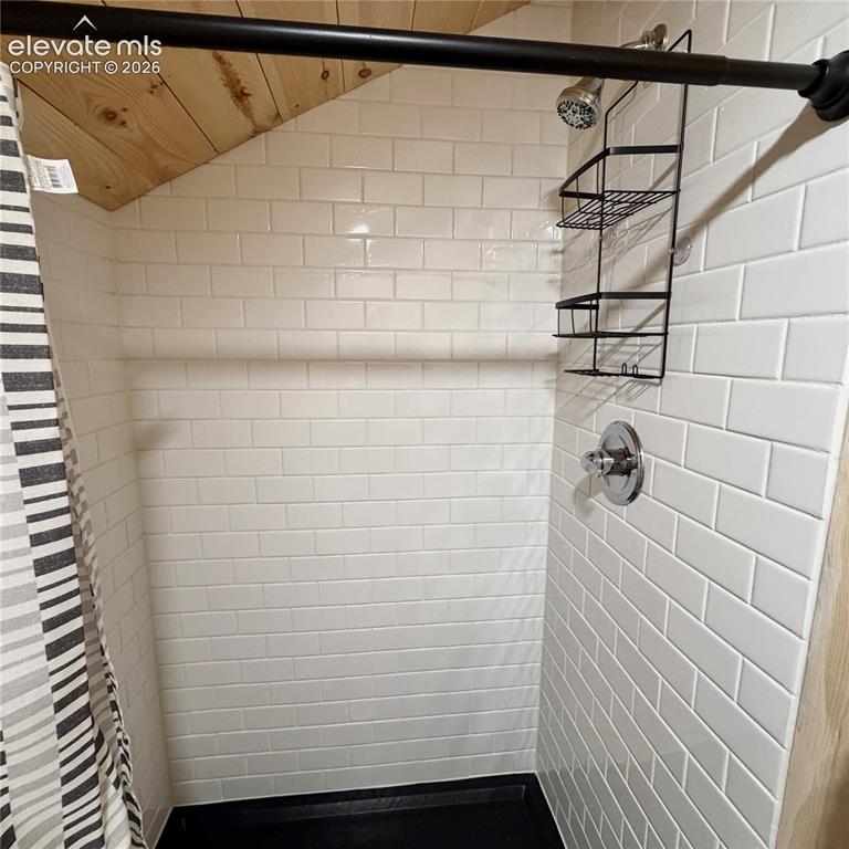 Image 19 of 45: Shower with white subway tile, black shower pan, and chrome fixtures