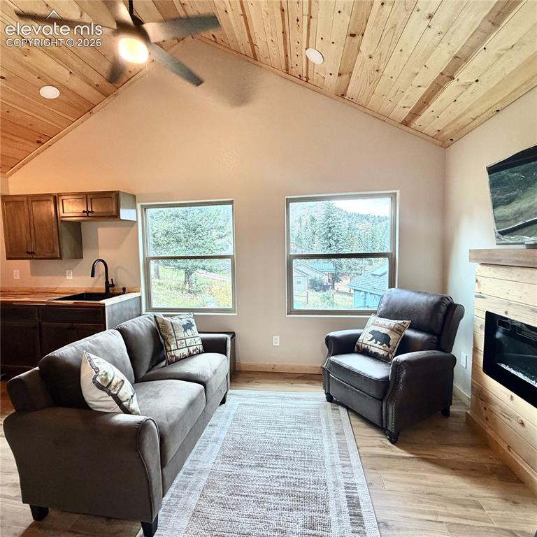 Image 2 of 45: Vaulted wood-paneled ceiling with recessed lighting and ceiling fan