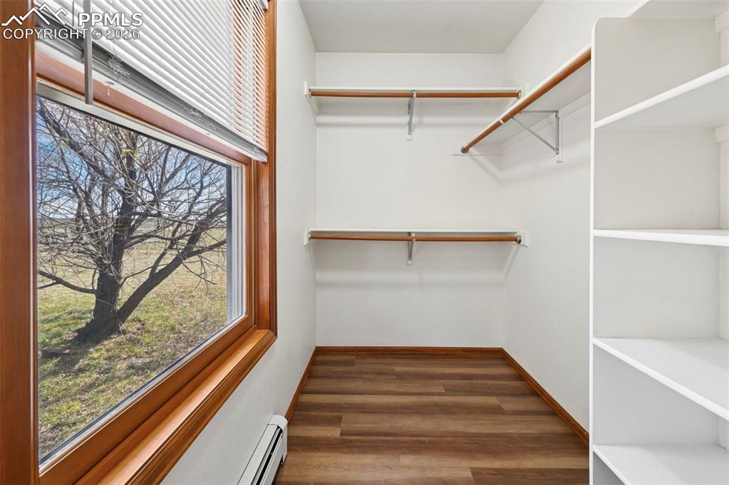 Image 24 of 49: Bedroom #1 New LVP flooring- Walk in Closet! Heating system is hot water t