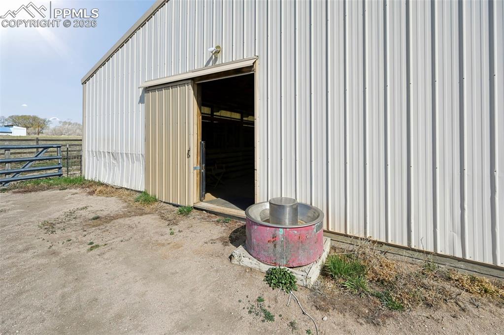 Image 42 of 49: Interior Hitching Post/ 3 stalls with mats and feeders/Hay Storage or room