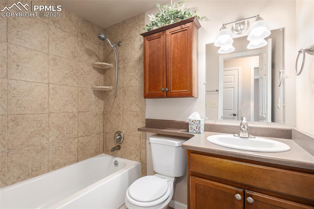 Image 12 of 29: Full bathroom with vanity and tub / shower combination